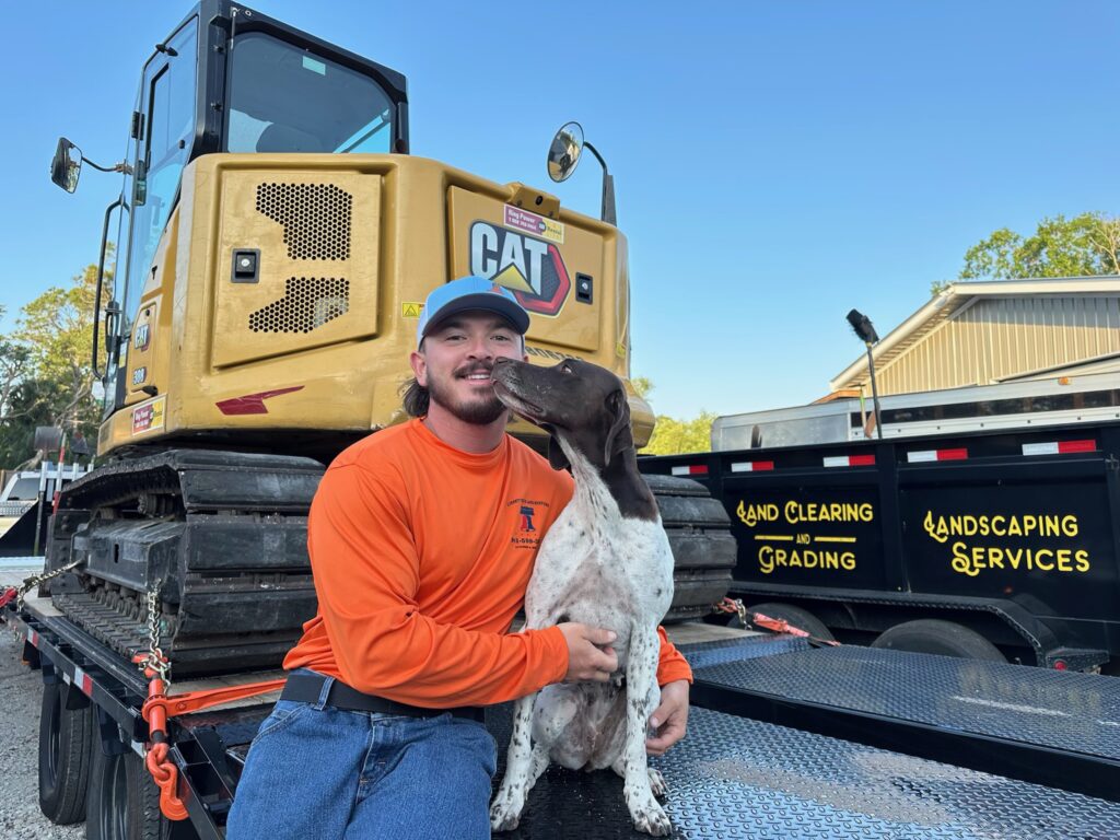 Brady, Owner and operator of Liberty Tree and Land Services with his dog, River.