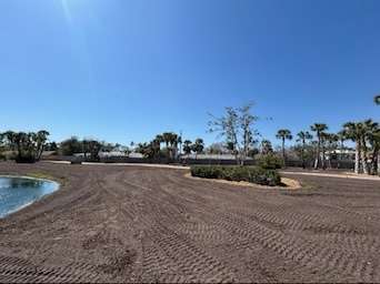 Soil grading with excavator.