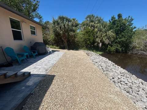 Yard excavated and graded to prepare for hardscaping and rip rap for better drainage.