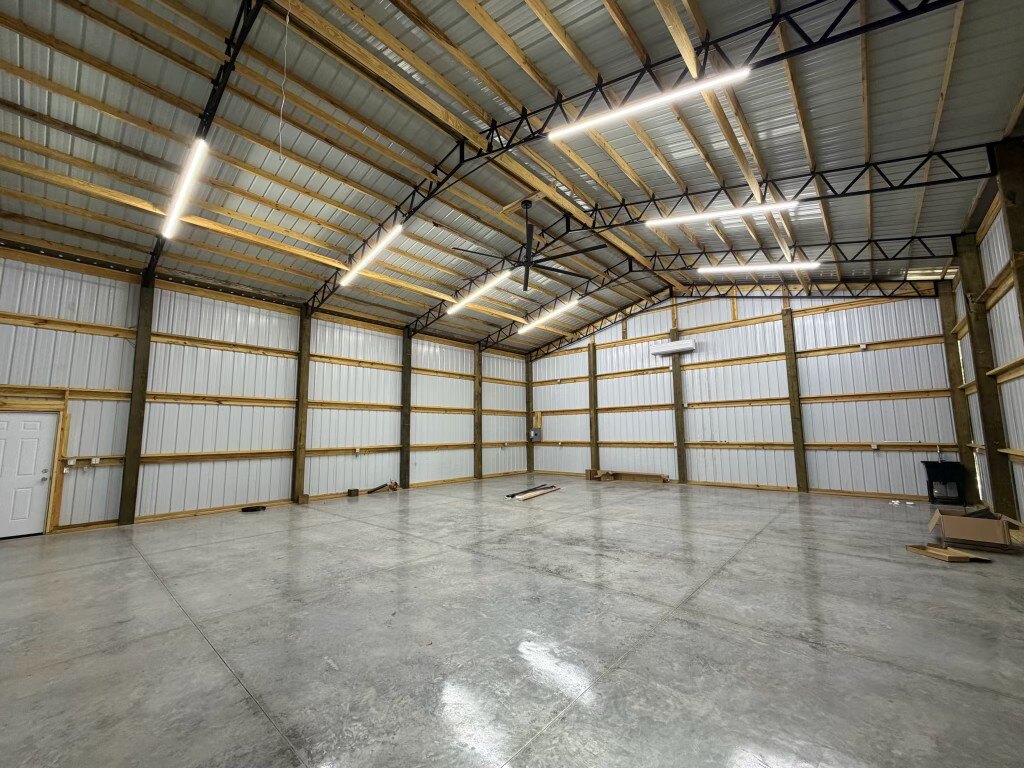 Finished concrete slab floor with control joints inside a large metal building