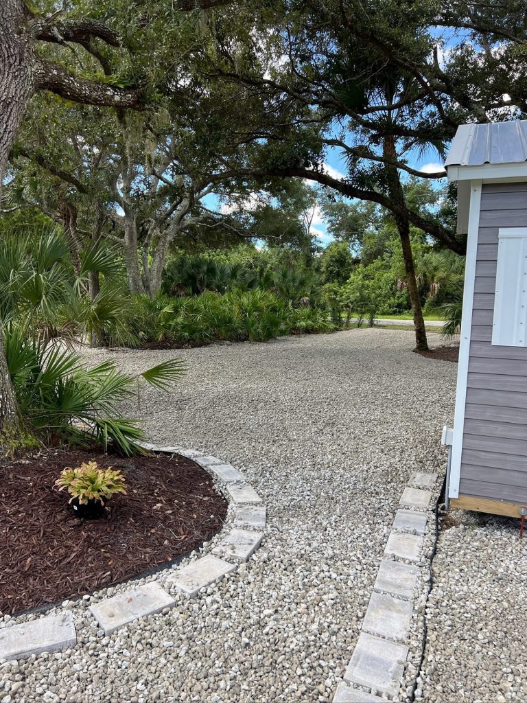 Gravel path with paver edging and mulched planting bed in Sarasota County