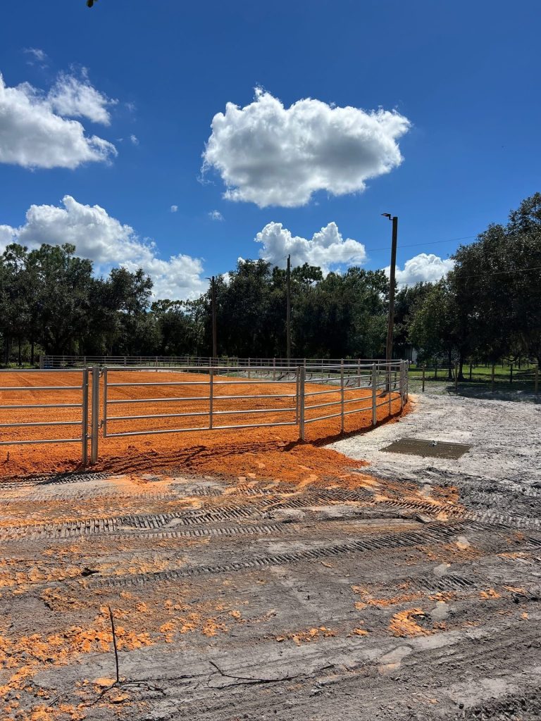 Graded perimeter and steel pipe-rail fencing on a Liberty Services horse arena build