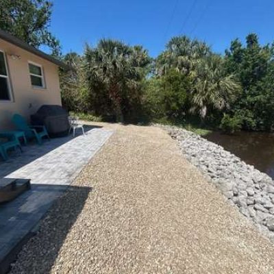Yard excavated and graded to prepare for hardscaping and rip rap for better drainage.