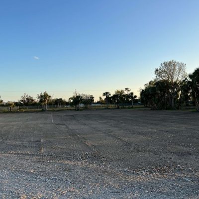 Site graded with excavation equipment to prepare for a construction project.