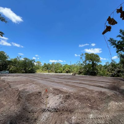Site graded with excavation equipment to prepare for a construction project.