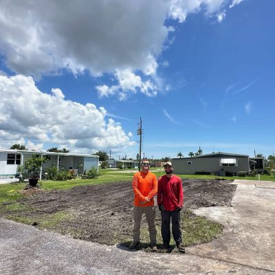 Liberty Tree and Land Services standing near a recent land clearing job.