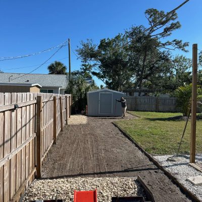 Hardscaping services with mini skid steer and rake.
