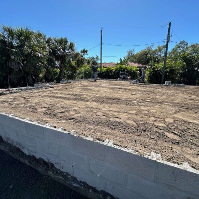 Site graded with excavation equipment to prepare for a construction project.