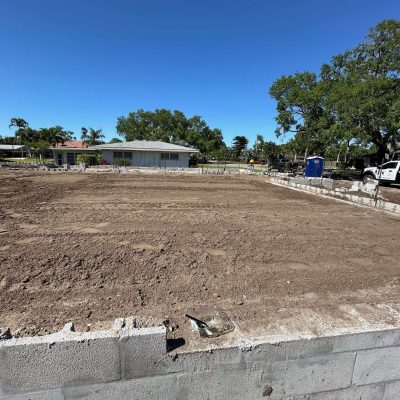Site graded with excavation equipment to prepare for a construction project.