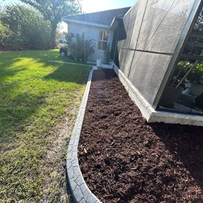 Established garden bed with stone boarder and fresh mulch.