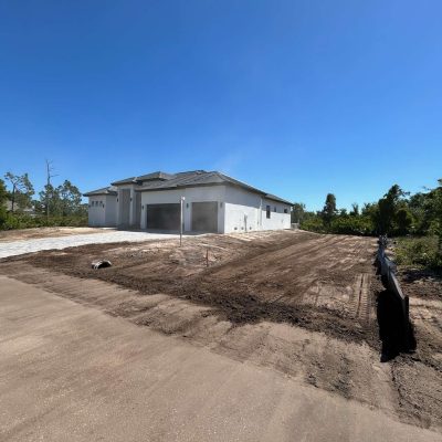 Site graded with excavation equipment to prepare for a construction project.
