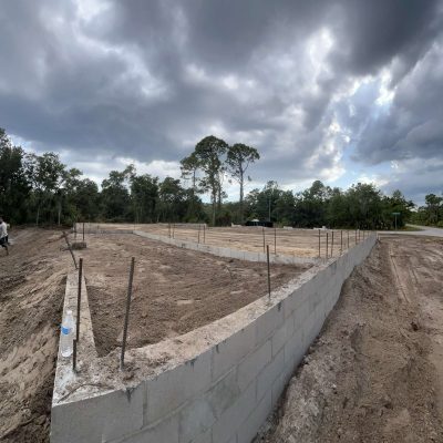 Site graded with excavation equipment to prepare for a construction project.